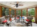 Relaxing screened porch with comfortable seating, ceiling fan, and a view of the sparkling pool and lush greenery at 130 Allie Drive, Mcdonough, GA 30252