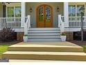 Elegant front entrance featuring a beautiful arched double door and decorative sidelights at 405 Highgrove Dr, Fayetteville, GA 30215