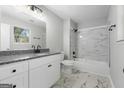 Stylish bathroom with a marble-tiled shower and floors, granite countertop, and neutral paint that creates a spa-like feel at 1404 Meadowind Court Sw, Conyers, GA 30094