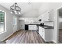 Bright kitchen featuring white cabinets, granite countertops, and stainless steel appliances at 1425 Meadowind Court Sw, Conyers, GA 30094
