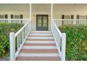 Welcoming front porch with elegant double doors and meticulously maintained shrubs at 212 Warrenton Dr, Douglasville, GA 30134
