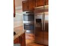 Modern kitchen featuring stainless steel appliances, including a built-in oven and refrigerator at 1055 Worthington Hills Dr, Roswell, GA 30076