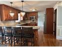 Spacious kitchen with wood cabinets, granite countertops, stainless steel appliances, and hardwood floors at 1055 Worthington Hills Dr, Roswell, GA 30076