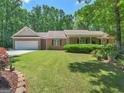 Attractive single-story brick home featuring a well-maintained front lawn, trimmed shrubbery and covered entryway at 175 N Unity Grove Rd, Locust Grove, GA 30248