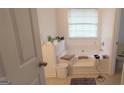 Bathroom featuring a tub with a large window, and a tiled shower area at 11950 Markham Way, Hampton, GA 30228