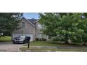 Charming brick home with a two-car garage and lush green lawn at 11950 Markham Way, Hampton, GA 30228