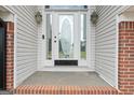 Close-up of the front door that has an ornate glass design, sidelights, and brick trim at 175 Dove Pt, Covington, GA 30016