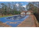 Community pool with winter cover and Tudor style pool house offers recreation and relaxation at 3189 Abbeywood Dr, Decatur, GA 30034
