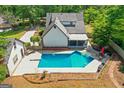 Aerial view displays the private backyard oasis with an inground pool and lounging area at 332 Judy Dr, Mcdonough, GA 30253
