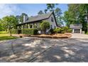 Well-maintained home with a covered porch, mature landscaping, and an extended driveway at 332 Judy Dr, Mcdonough, GA 30253