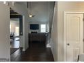 Open-concept living room with hardwood floors, a ceiling fan, and view of a dining space at 3970 Lagrone St, Powder Springs, GA 30127