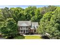 Stately brick home with dual porches, set amidst mature trees and meticulously maintained landscaping at 218 Woodruff Way, Peachtree City, GA 30269