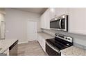 Modern kitchen featuring stainless steel appliances, granite countertops, and ample white cabinetry at 3 Roving Hills Cir, Cartersville, GA 30121
