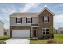 Two-story home showcasing brick and siding, a two-car garage, and red shutters at 2358 Argento Cir, Dacula, GA 30019