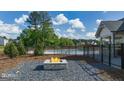 Outdoor fire pit and seating area near the pool, with a glimpse of the community amenities at 560 Whitman Ln # 2016, Stockbridge, GA 30281