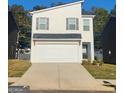 Charming two-story home featuring a painted brick facade, attached garage, and a paved driveway at 4831 Station Lane # 29, Union City, GA 30349