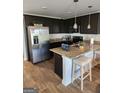 Modern kitchen with stainless steel appliances, granite countertops, and a breakfast bar with seating at 4831 Station Lane # 29, Union City, GA 30349