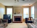 Bright living room featuring a brick fireplace and natural light at 3838 Kirkwood Nw Run, Kennesaw, GA 30144