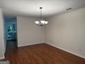 Bright dining room featuring hardwood floors, crown molding, and modern lighting fixture at 6190 Douglas Manor Ct, Douglasville, GA 30134