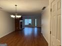 Inviting living room with hardwood floors, a brick fireplace, and natural light from the window at 6190 Douglas Manor Ct, Douglasville, GA 30134
