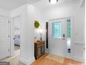 Bright entryway featuring hardwood floors, fresh white paint and a decorative front door at 1585 Lake Dow Rd, Mcdonough, GA 30252