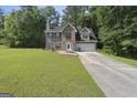 Two-story brick home with blue shutters, attached two-car garage and manicured lawn at 96 Ashtonbrook Dr, Mcdonough, GA 30252