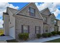 Charming home with brick facade, lush greenery, and a convenient side-entry garage adding to its appeal at 1441 Saint George Pl, Conyers, GA 30012