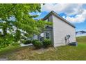 Traditional-style home boasts well-maintained landscaping, and mature trees providing shade and curb appeal at 1441 Saint George Pl, Conyers, GA 30012