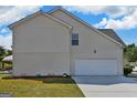 This home features a convenient two car garage with a clean and simple design at 1441 Saint George Pl, Conyers, GA 30012