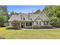 Charming exterior featuring dormer windows, a well-manicured lawn, and classic architectural details at 465 Crabapple Rd, Fayetteville, GA 30215