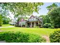Exterior view of a craftsman style home with a well-manicured lawn, mature trees, and inviting curb appeal in a neighborhood setting at 125 High Bluff Trl, Carrollton, GA 30116
