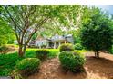 View of a home in a lush, green setting showcasing beautiful landscaping and mature trees offering privacy and natural beauty at 125 High Bluff Trl, Carrollton, GA 30116