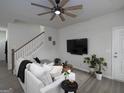 Comfortable living area featuring a cozy couch, modern decor, and staircase at 2108 Remy Ct, Kennesaw, GA 30144