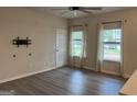 Inviting living room with light gray wood floors, white walls, and plenty of natural light at 2108 Remy Ct, Kennesaw, GA 30144