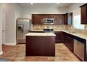 Beautiful kitchen with stainless steel appliances, granite countertops, and a central island at 620 Sedona Loop, Hampton, GA 30228