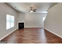 Inviting living room featuring hardwood floors, a fireplace, and an elegant ceiling fan at 620 Sedona Loop, Hampton, GA 30228