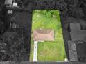 Aerial view showcases a rectangular, grassy lot surrounding the home with a long driveway at 840 Jett Rd, Jonesboro, GA 30236