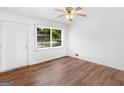 Well-lit bedroom with wood floors, a ceiling fan, and a large window with backyard view at 840 Jett Rd, Jonesboro, GA 30236