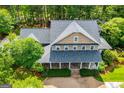 Overhead view of a two-story home with a large covered front porch at 115 Champion Dr, Carrollton, GA 30116