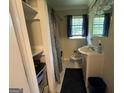 A full bathroom features a shower with curtain, toilet, sink and cabinet, mirror, and some storage at 1711 Mckenzie Dr, Decatur, GA 30032
