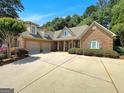 Charming brick home with a two-car garage and a spacious driveway at 211 English Oaks Ln, Mcdonough, GA 30253