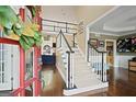 Welcoming foyer with hardwood floors, staircase, and views into the living spaces at 6317 Benbrooke Nw Overlook, Acworth, GA 30101