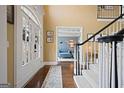 Bright foyer showcasing hardwood floors, staircase, and access to living spaces at 6317 Benbrooke Nw Overlook, Acworth, GA 30101