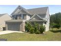 Well-kept two-story home with brick and siding, featuring an attached two-car garage and manicured front yard at 2282 Joplin St, Jonesboro, GA 30236