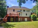 Expansive backyard with a wooden deck, a partial brick facade, and ample green space at 308 Bell Isle, Mcdonough, GA 30252
