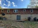 View of the rear of the house with brick and cement block and basement access at 1858 Sahara Se Dr, Atlanta, GA 30316