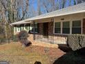 Quaint brick home with shutters and front porch, a classic design at 1858 Sahara Se Dr, Atlanta, GA 30316