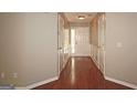 Well-lit hallway with hardwood floors and detailed trim work throughout at 3350 Cooper Woods Dr, Loganville, GA 30052