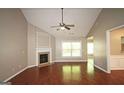 Inviting living room features a fireplace, hardwood floors, and lots of natural light at 3350 Cooper Woods Dr, Loganville, GA 30052