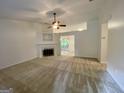 Spacious living room with a cozy fireplace and neutral carpet, creating a warm atmosphere at 6026 Woodcreek Dr, Woodstock, GA 30188